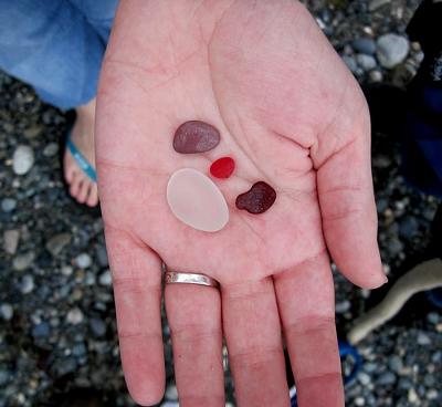 Addie's two rare red and her very rare purple sea glass