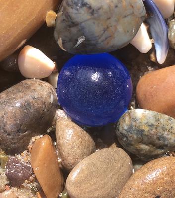 Blue sea glass orb looks like a gem
