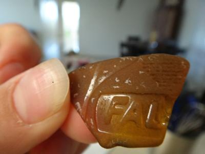 Identification. Brown sea glass with FAL...