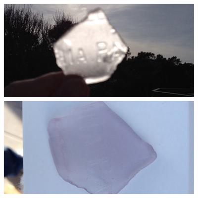 Light purple sea glass with writing -