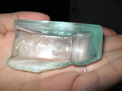 Aqua sea glass with the letters AY'S