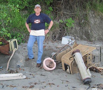 David looks at trash dumped over a 40-foot bluff.