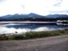 South across the still waters enclosed by the spit with ships for the lumber mills.